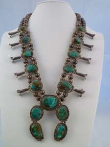 This is a 27 Navajo squash blossom necklace with green turquoise 